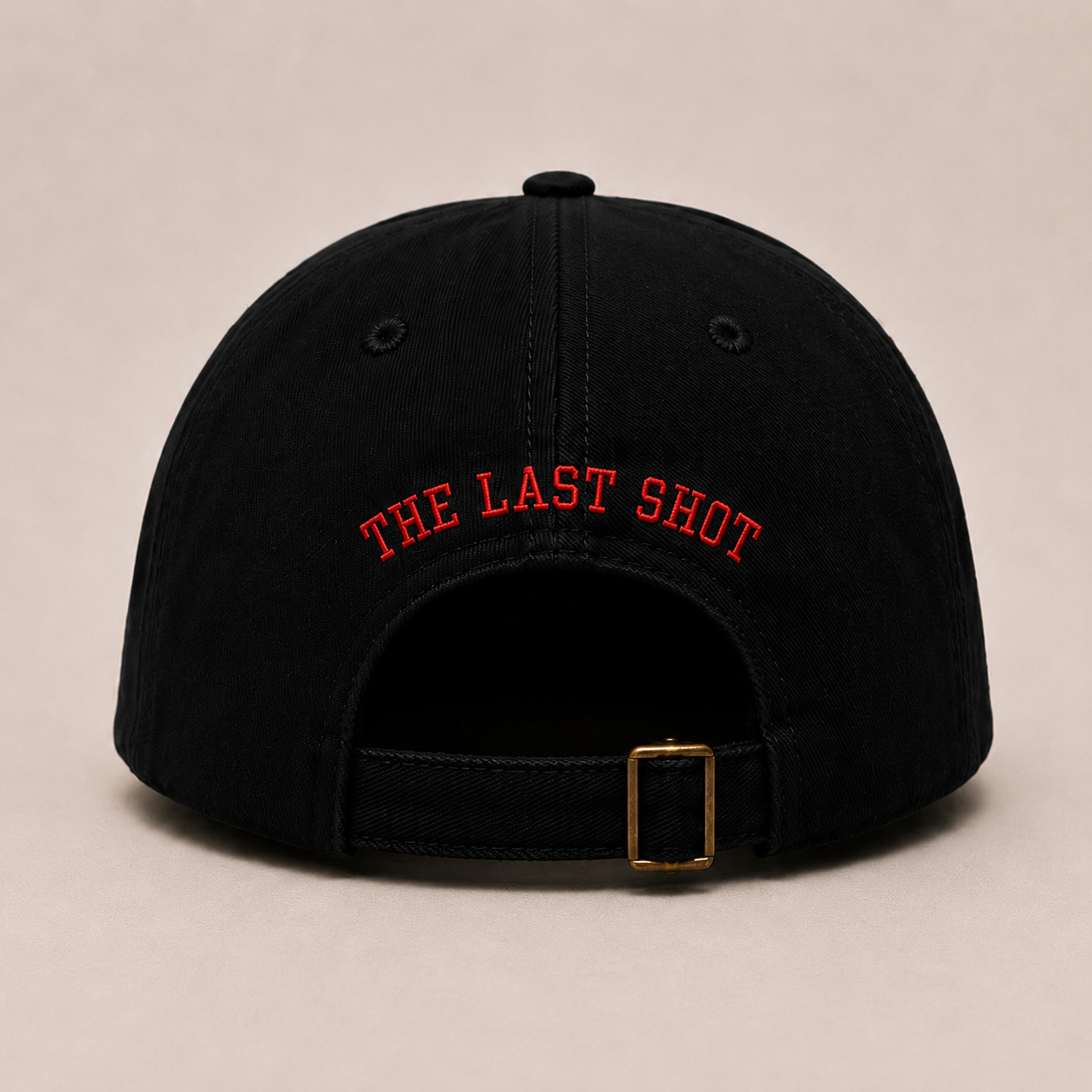 Back view of The Last Shot embroidered dad cap in black by Hai Tide showing the rear embroidery and adjustable strap closure on a premium six-panel cotton dad cap.